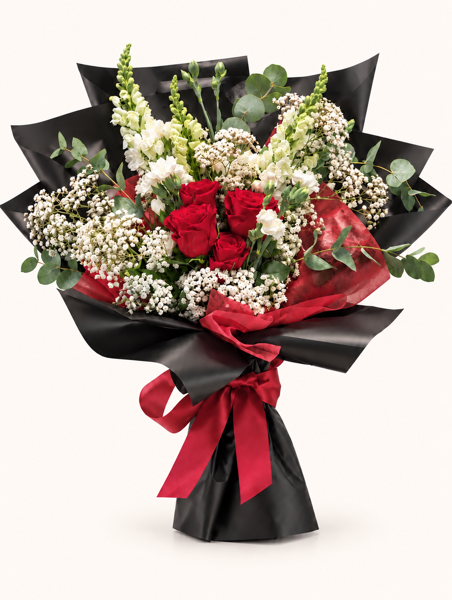 Scarlet Devotion red rose bouquet with black and crimson wrapping on an ivory background